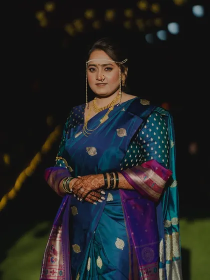 A poised and elegant portrait of the bride in her stunning blue Nauvari.