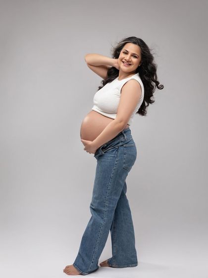 A full-length profile in the jeans and top, showing off the beautiful pregnancy silhouette in a casual, modern way.