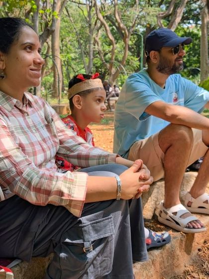 A family listens intently during a nature storytelling session. Sharing these experiences together strengthens bonds and creates lasting memories.