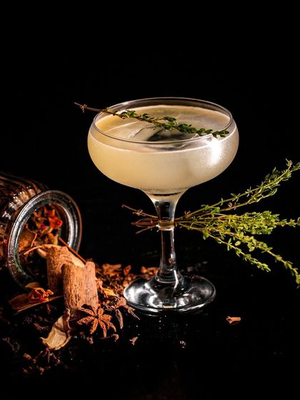 A simple yet elegant Gin & Tonic, elevated with a sprig of fresh thyme. It's the small details that make our classic cocktails stand out.