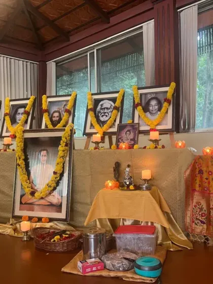 Our altar, beautifully decorated for our Janmashtami celebration. We honor our line of gurus, including Paramhansa Yogananda and Swami Kriyananda, with flowers, candles, and devotion, creating a sacred space for worship and meditation.