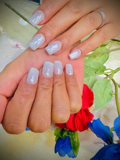 A close-up of the milky white nails, showing the smooth and even application.