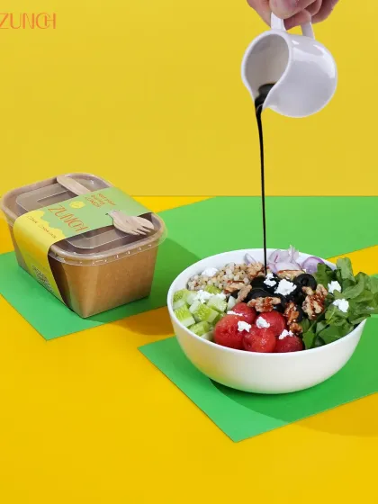 Here's our Tropical Toss bowl getting a drizzle of bold dressing. It's a mix of sweet watermelon, crunchy walnuts, and savory feta that keeps every bite exciting.