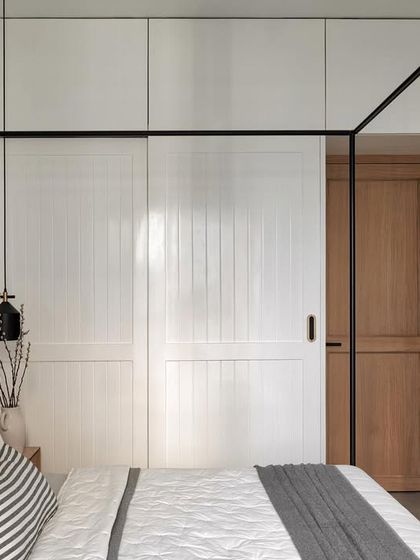 Due to the room's smaller size, I incorporated practical sliding wardrobes finished in matte white polyurethane (PU) to maximize space without sacrificing style.