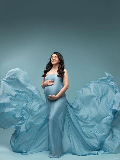 A soft smile and a gentle hold on her bump. This image is filled with the quiet joy and magic of waiting to meet your baby.