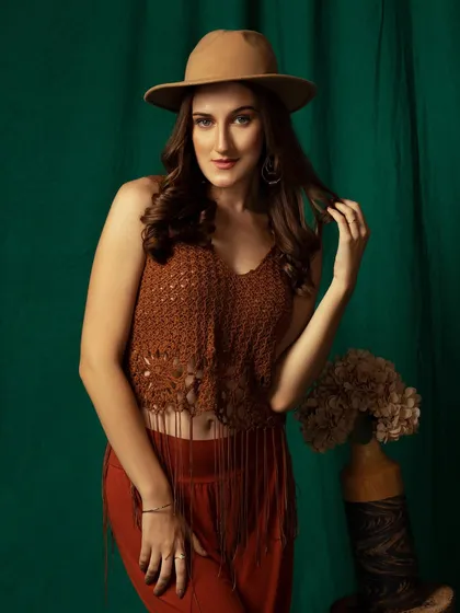 A mid-body shot that shows the full boho-inspired outfit. The props and background complete the look.