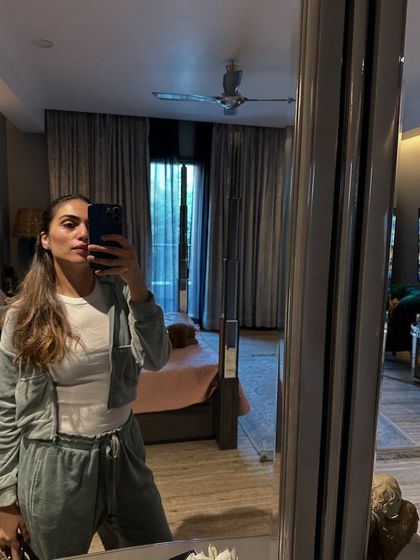 Another cozy look, this time a grey cropped hoodie and matching sweatpants. Athleisure can be both comfortable and chic.