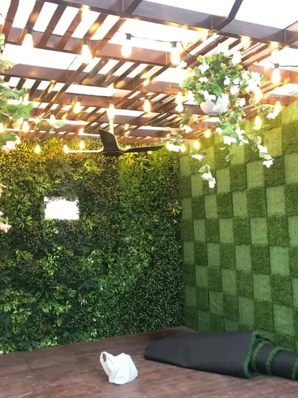 A wider shot of the checkerboard green wall under the pergola. This design is a great example of how we can play with patterns and textures to create a unique look.
