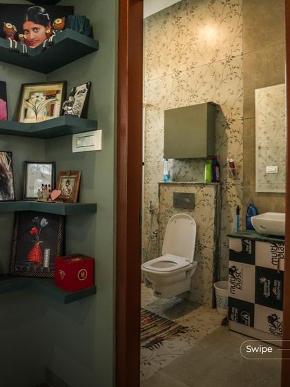 Even small spaces can be filled with personality. This corner features custom floating shelves that provide a place to display cherished family photos and art, turning a simple wall into a gallery of memories.