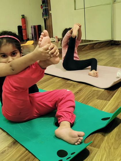 It is a joy to watch these little yogis explore their flexibility and strength. This young student is practicing a variation of a seated leg cradle, which is wonderful for opening the hips.