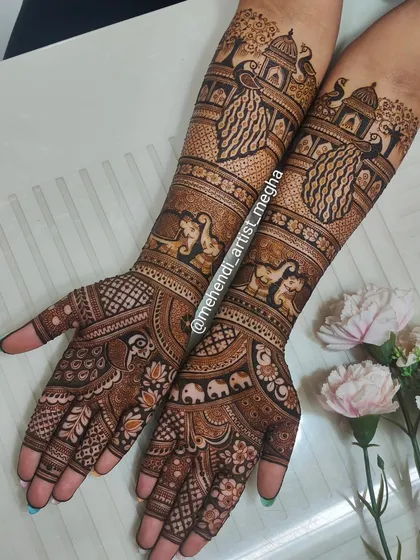 This is a full bridal story on both arms. I've combined architectural elements like domes with traditional motifs like peacocks and elephants to create a rich, narrative design that is completely unique to the bride.