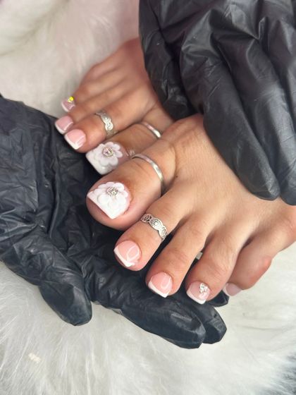 Another angle of this elegant pedicure, showing the classic white tip and the sparkling rhinestone in the center of the 3D flower.