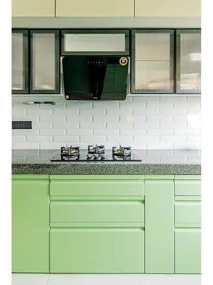 A clean, straight-on view of the hob and chimney area. The handle-less drawers and cabinets create a sleek, modern look.