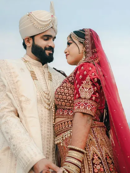 A beautiful close up of a couple sharing a look of love, with the sea and sky creating a serene and picturesque background.