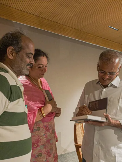An author signing a book for an eager couple. These moments of connection between writers and readers are the essence of what we do.