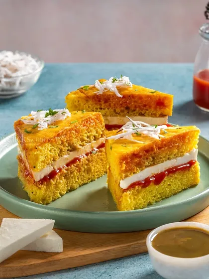 A unique Dhokla Sandwich from Gulab Sweets, layered with chutney and paneer.
