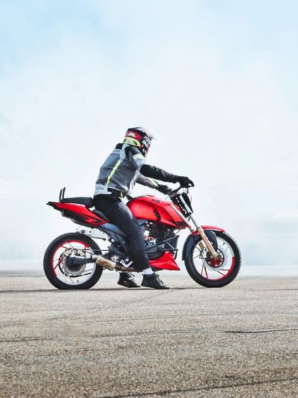 The same red stunt bike, emerging from a cloud of smoke. These dramatic visuals are perfect for creating compelling promotional content.