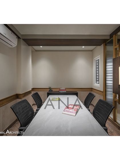 A side view of the conference room, highlighting the custom artwork display panel. This feature integrates the client's art collection directly into the office's architectural elements.