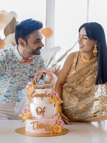 A beautiful moment captured with a client couple celebrating their 10th anniversary with a custom three-tier cake. The design includes an edible photo and sugar flowers, symbolizing their journey together.