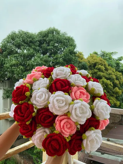 A full, vibrant bouquet of red, pink, and white roses.