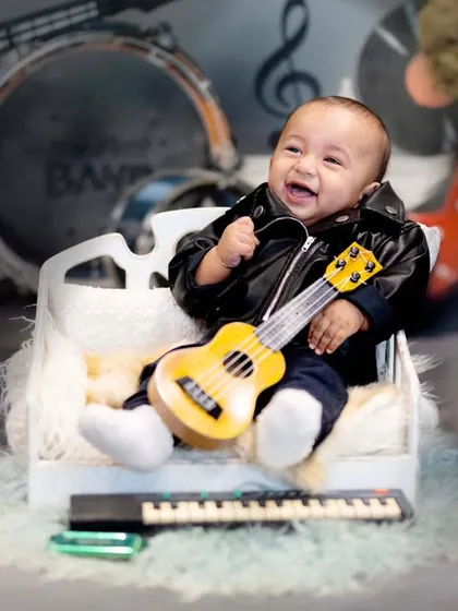 A big laugh from our little rockstar. The joy on his face is what makes these themed sessions so special and memorable.