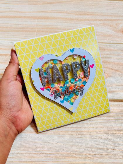 A birthday pop-up card with a shaker heart, perfect for him. It can be customized with any theme and holds 4 pictures and 2 messages.