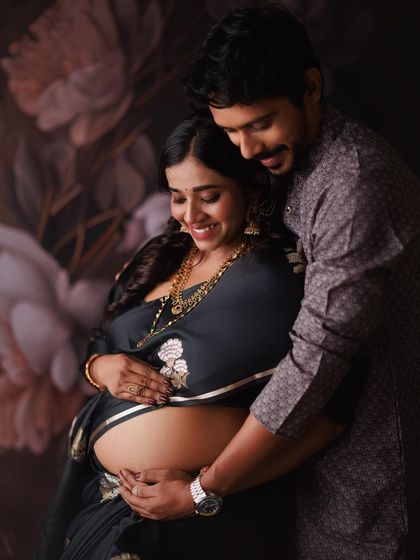 I love the way he wraps his arms around her and her precious bump. This is a beautiful, intimate moment from a traditional maternity photoshoot, celebrating their journey to parenthood.
