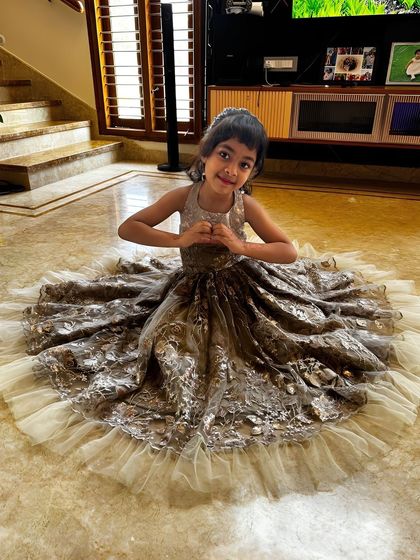 My prettiest doll in a custom gown. This little princess is wearing a beautiful dress with a detailed lace and sequin overlay and a full tulle skirt, perfect for any grand celebration.