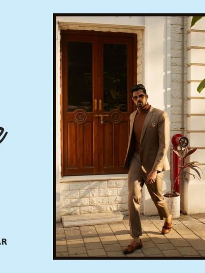 A clean, contemporary menswear look featuring a tonal brown suit paired with a turtleneck. This street-style editorial shot captures a sense of modern Italian elegance and effortless cool.