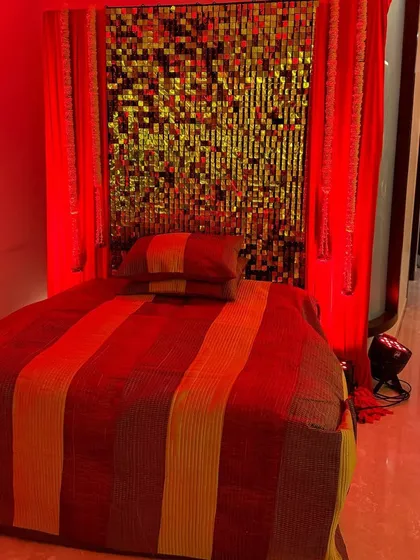 Setting the mood for a Sufi night at home. We used a gold sequin backdrop and dramatic red lighting to create a rich and ambient seating area.