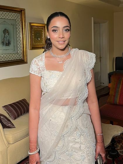This bride's mega-watt glow was the centerpiece of her look. Paired with a sleek ponytail and a stunning white saree, the dewy, luminous skin makes a powerful statement.