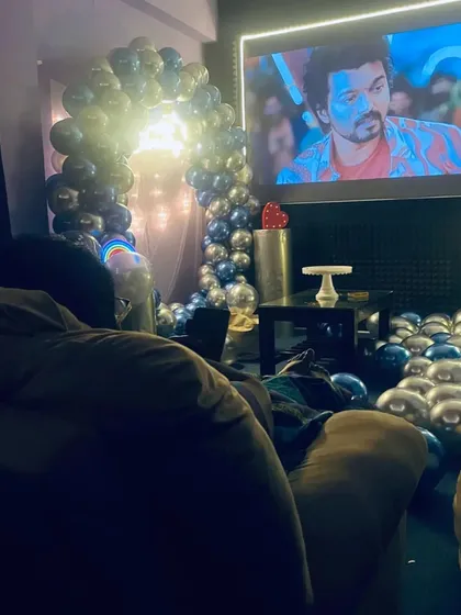 From the comfort of a beanbag chair, this is the view of a birthday movie night, with the balloon arch framing the screen.