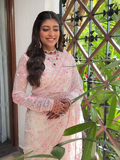 This bride's wedding look was all about softness. I used pink shimmery eyes and flushed cheeks for a natural glow that perfectly complemented her floral Sabyasachi saree.