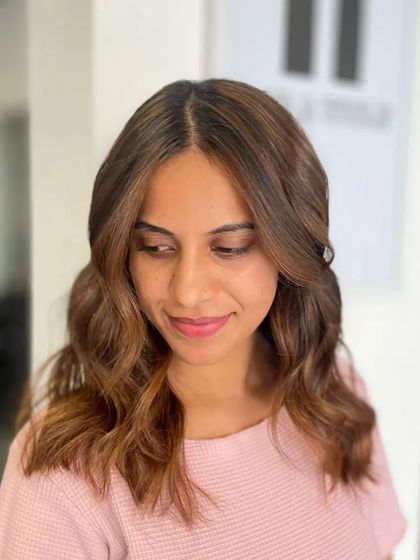 Another portrait, capturing the joy of a fresh hairstyle.