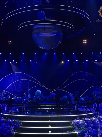 The stage was the heart of our galaxy. I designed a multi-layered backdrop depicting cosmic waves and a starry night, with a large planet suspended above the central platform, creating a truly stellar focal point.