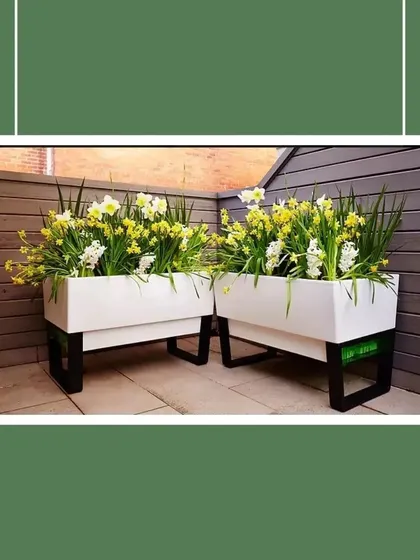 Planters on stands are a great way to create height and dimension in your garden design. These rectangular planters are elevated on simple black metal frames, giving them a modern, airy feel that works well in contemporary spaces.