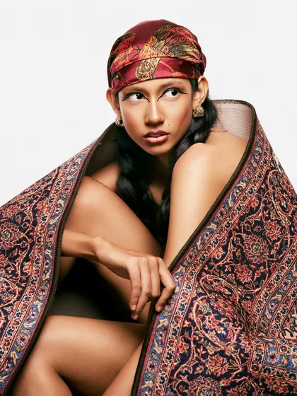 The direct gaze in this shot emphasizes the power of the graphic eyeliner. It's a look that is both a nod to tradition and a statement of modern confidence.