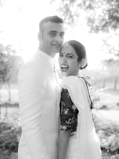 Pure, uninhibited laughter. This candid black and white photo captures a moment of shared joy between the couple, showcasing their easy and happy connection.