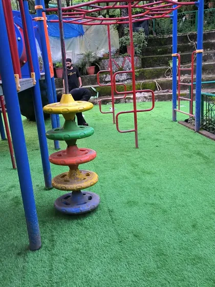 The vibrant green of the artificial grass makes the colorful play equipment stand out even more.