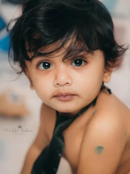 A stunning close-up of our little boss. His intense gaze and adorable face make this a powerful and memorable portrait.