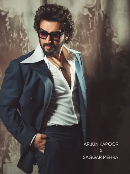 I styled Arjun Kapoor in this ensemble that channels a retro sensibility with a modern edge. The look is built around a deep blue suit with a wide, statement collar, creating a silhouette that is both timeless and unapologetically bold.