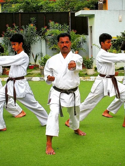 As a Renshi, I lead every class personally, ensuring each student masters the fundamental stances and punches. Here, we practice the zenkutsu-dachi stance, building a strong foundation together.