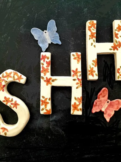 I can create custom ceramic nameplates and letters for your home. These letters are hand painted with a delicate floral pattern, and I added a couple of ceramic butterflies for a playful touch. It is a beautiful way to personalize your entryway.