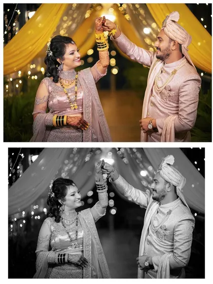 A playful dance moment under fairy lights at the wedding reception, shown in both color and black and white.