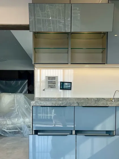 A look at the lift-up glass cabinets in our Matunga East project, providing easy access to stored items.