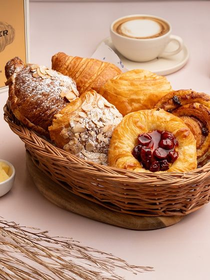 My pastry basket is a celebration of Viennoiserie. It features a selection of my finest laminated dough creations, including a classic butter croissant, almond croissant, pain aux raisin, and a fruit Danish.
