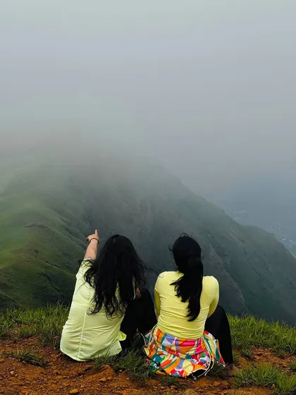 Two friends enjoying the misty view from the Netravati peak. It's a perfect trek to do with your gang.