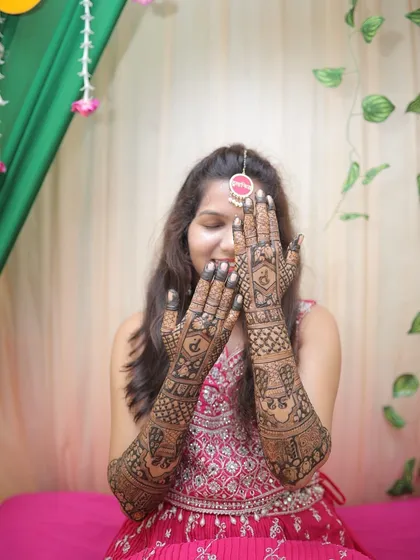 The bride showing off her full back-hand mehendi. The design is intricate and personalized, a perfect reflection of her style.