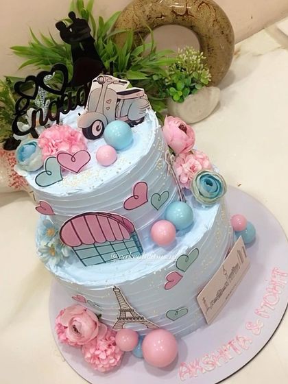 This thoughtful two-tier engagement cake tells the couple's story, depicting their journey of togetherness across Paris and Berlin. It's decorated with edible prints of the Eiffel Tower, hearts, and a scooter for a truly personal touch.