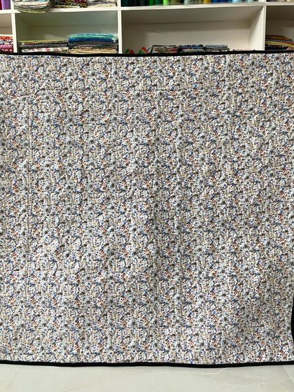 The back of the assorted baby quilt, featuring a simple, uniform pattern that is soft to the touch.